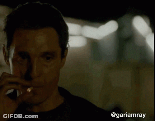 A Close Up Of A Man Smoking A Cigarette With The Hashtag @Gariamray At The Bottom GIF