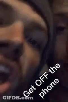 A Close Up Of A Man Talking On A Cell Phone With The Words `` Get Off The Phone '' . GIF