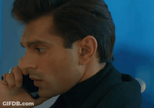 A Close Up Of A Man Talking On A Cellphone GIF