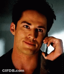 A Close Up Of A Man Talking On A Cellphone GIF