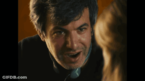 A Close Up Of A Man Talking On A Phone That Says Tesco GIF