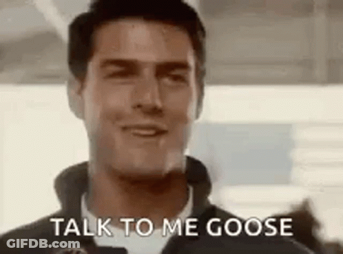 A Close Up Of A Man Talking To A Goose . GIF