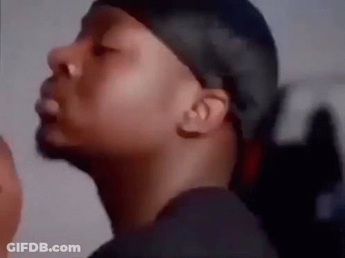A Close Up Of A Man Wearing A Bandana And A Black Shirt . GIF