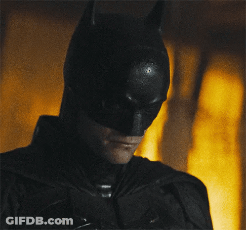 A Close Up Of A Man Wearing A Batman Costume GIF
