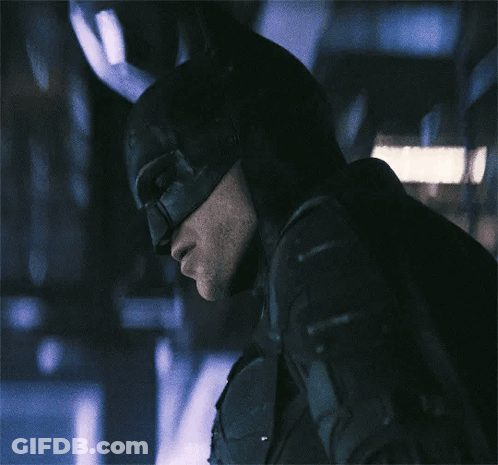 A Close Up Of A Man Wearing A Batman Costume GIF