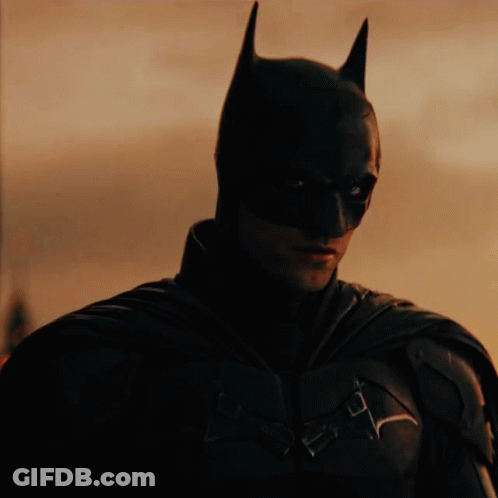 A Close Up Of A Man Wearing A Batman Mask GIF