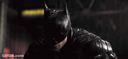 A Close Up Of A Man Wearing A Batman Mask In The Rain . GIF