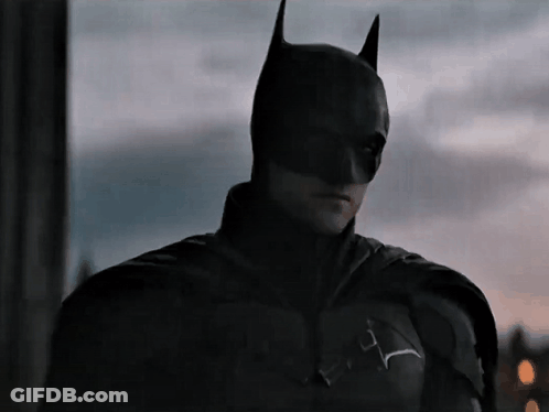 A Close Up Of A Man Wearing A Batman Mask GIF