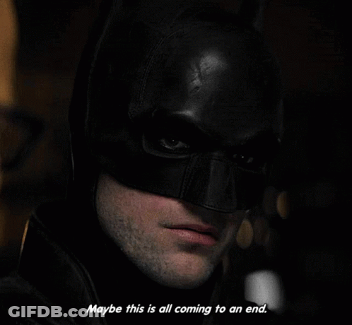 A Close Up Of A Man Wearing A Batman Mask With The Words " Maybe This Is All Coming To An End " GIF