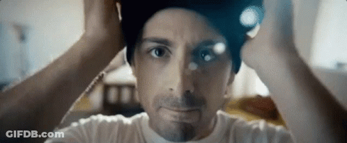 A Close Up Of A Man Wearing A Beanie On His Head . GIF