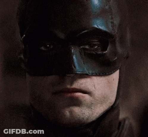 A Close Up Of A Man Wearing A Black Batman Mask GIF