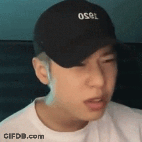 A Close Up Of A Man Wearing A Black Hat And A White Shirt . GIF
