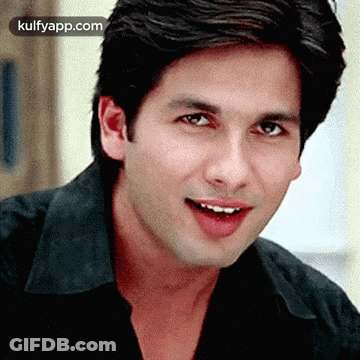 A Close Up Of A Man Wearing A Black Shirt And Smiling GIF
