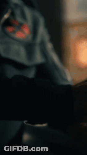 A Close Up Of A Man Wearing A Blue Jacket With A Red Cross On It GIF