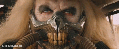 A Close Up Of A Man Wearing A Gas Mask With A Skull On It . GIF