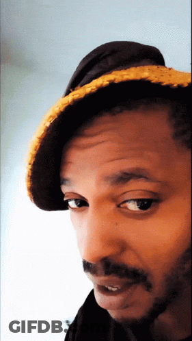 A Close Up Of A Man Wearing A Hat And A Beard GIF