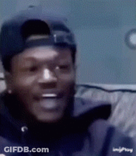 A Close Up Of A Man Wearing A Hat And A Jacket That Says Imgplay GIF