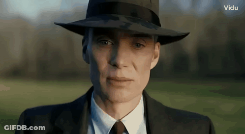 A Close Up Of A Man Wearing A Hat And A Suit GIF