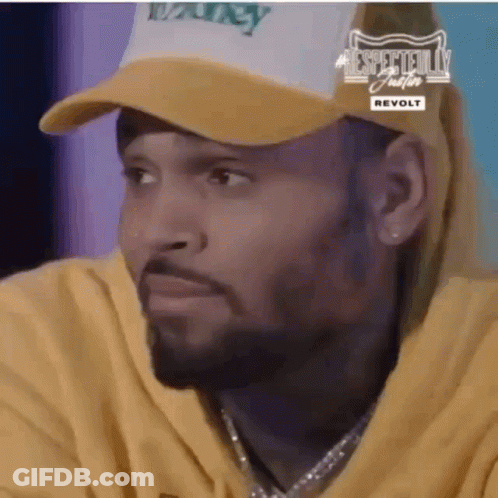 A Close Up Of A Man Wearing A Hat And A Yellow Hoodie . GIF