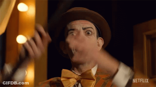 A Close Up Of A Man Wearing A Hat And Bow Tie Making A Funny Face . GIF