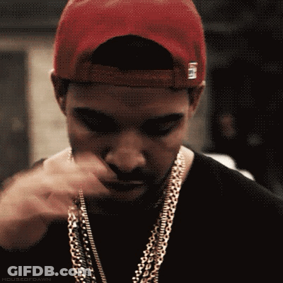 A Close Up Of A Man Wearing A Hat And Chains GIF