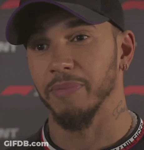 A Close Up Of A Man Wearing A Hat And Earrings Saying `` I 'M Definitely Not Fast '' . GIF