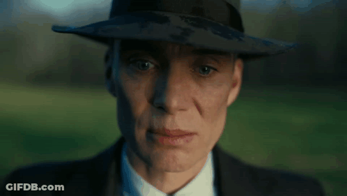 A Close Up Of A Man Wearing A Hat And Suit GIF