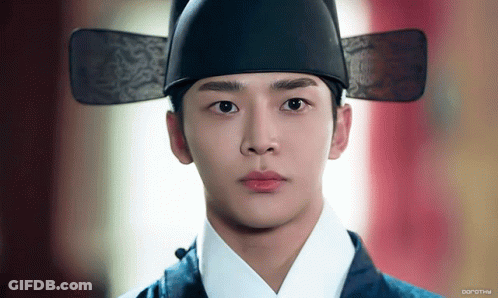 A Close Up Of A Man Wearing A Hat With The Word Dorothy On The Bottom Right GIF