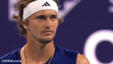 A Close Up Of A Man Wearing A Headband And A Necklace . GIF