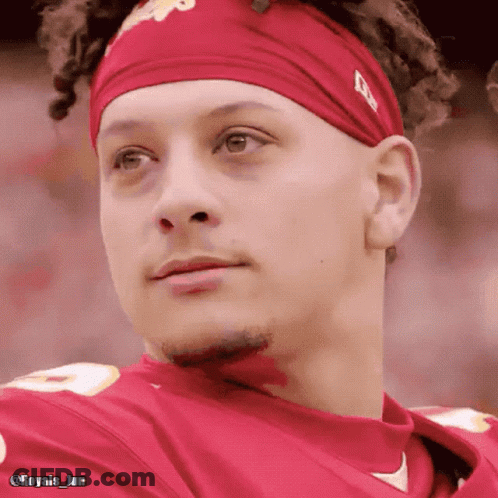 A Close Up Of A Man Wearing A Headband And A Red Shirt GIF