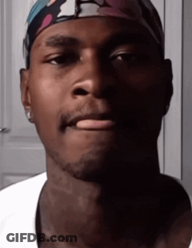 A Close Up Of A Man Wearing A Headband GIF