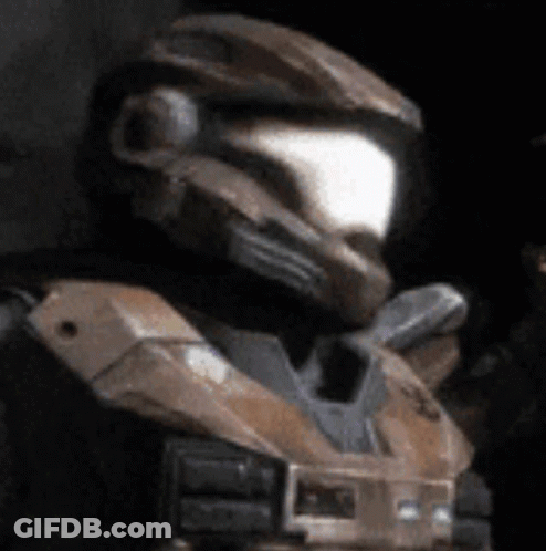 A Close Up Of A Man Wearing A Helmet And A Black Vest GIF