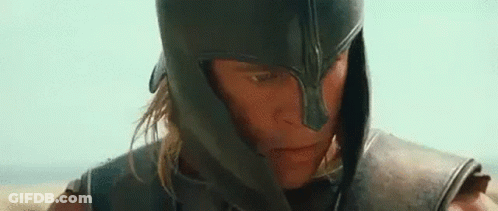 A Close Up Of A Man Wearing A Helmet And Armor Looking At The Camera . GIF