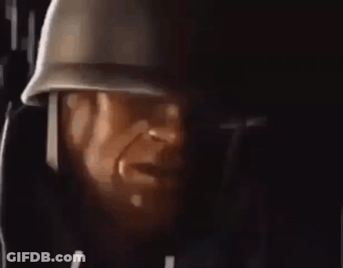 A Close Up Of A Man Wearing A Helmet And Headphones . GIF
