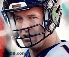 A Close Up Of A Man Wearing A Helmet With The Word Broncos On It GIF