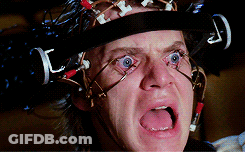A Close Up Of A Man Wearing A Helmet With Wires Attached To It GIF