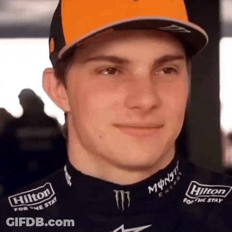 A Close Up Of A Man Wearing A Hilton For The Stay Shirt GIF