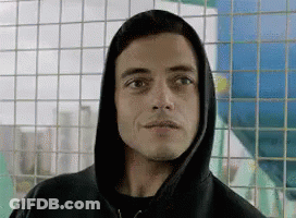 A Close Up Of A Man Wearing A Hoodie Looking At The Camera . GIF