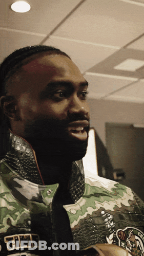 A Close Up Of A Man Wearing A Jacket That Says Celtics GIF