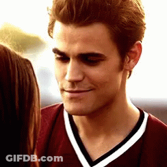 A Close Up Of A Man Wearing A Maroon Shirt With White Stripes GIF