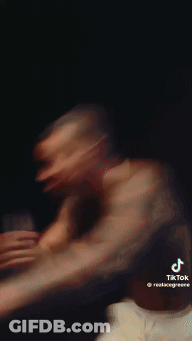 A Close Up Of A Man Wearing A Necklace . GIF