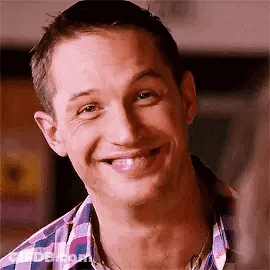 A Close Up Of A Man Wearing A Plaid Shirt And Smiling . GIF