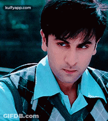 A Close Up Of A Man Wearing A Plaid Vest And A White Shirt . GIF