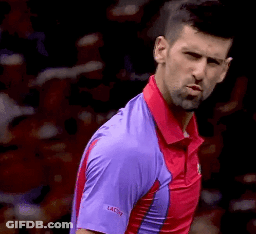 A Close Up Of A Man Wearing A Purple Shirt That Says Lacoste GIF