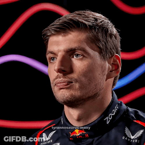 A Close Up Of A Man Wearing A Red Bull Racing Suit GIF