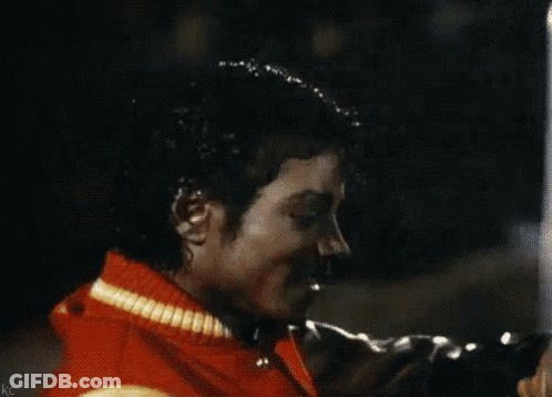 A Close Up Of A Man Wearing A Red Jacket With A Yellow Stripe GIF