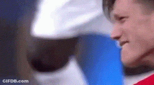 A Close Up Of A Man Wearing A Red Shirt And A White Hat . GIF