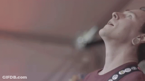 A Close Up Of A Man Wearing A Red Shirt With A Black Strap With Buttons On It That Say " I Love You " GIF