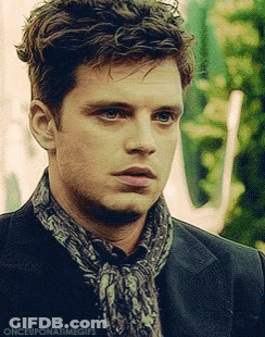 A Close Up Of A Man Wearing A Scarf And A Jacket . GIF