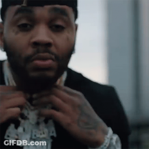 A Close Up Of A Man Wearing A Suit And A Hat . GIF